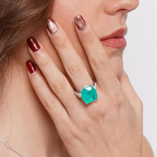 Metal ring with central green zircon