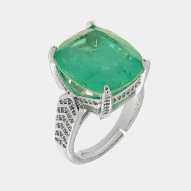 Metal ring with central green zircon