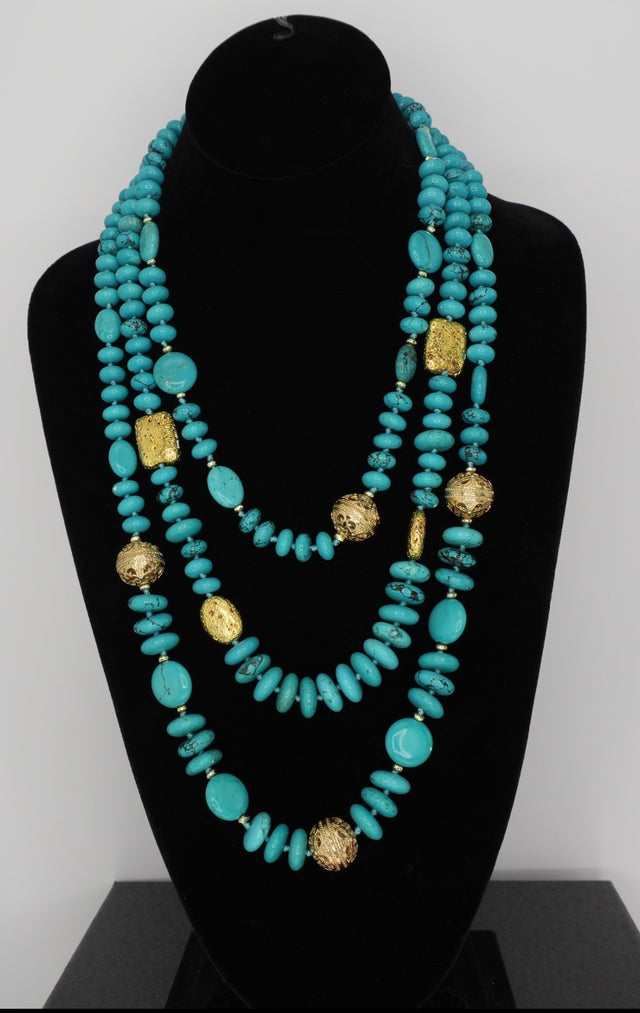 Multi-strand blue turquoise necklace featuring gold-plated accents beads