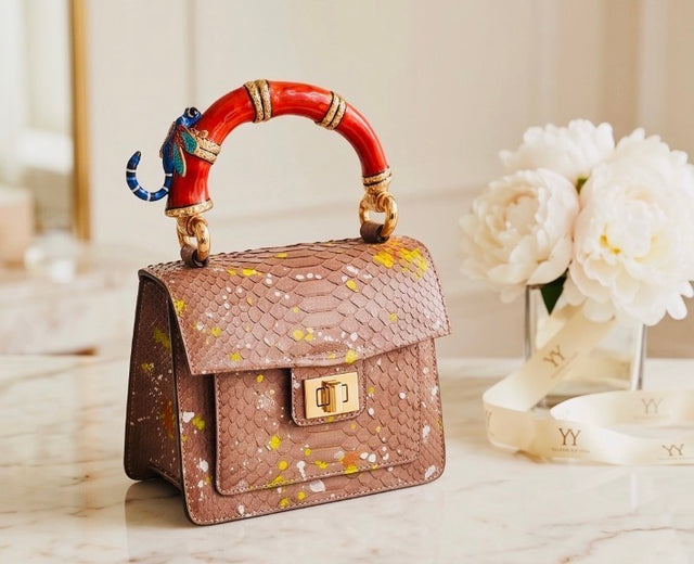 Poudre Python Art Bag with red top handle and blue dragonfly charm