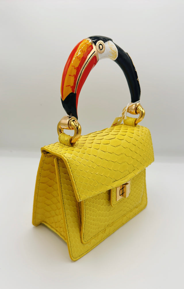 Yellow python handbag with hand-painted toucan bird enamelled brass handle