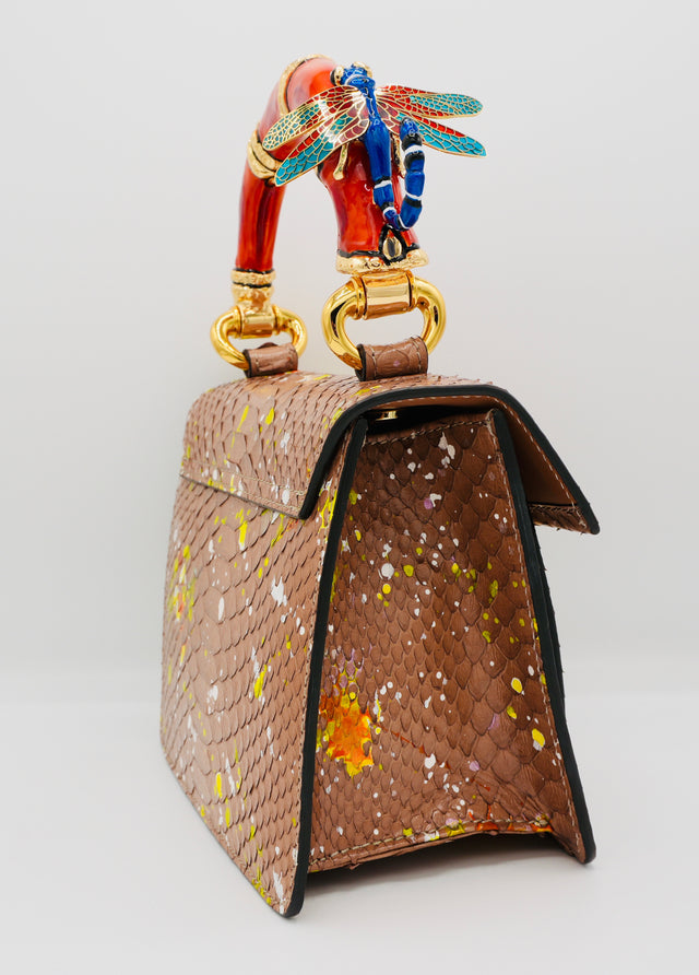 Poudre Python Art Bag with red top handle and blue dragonfly charm