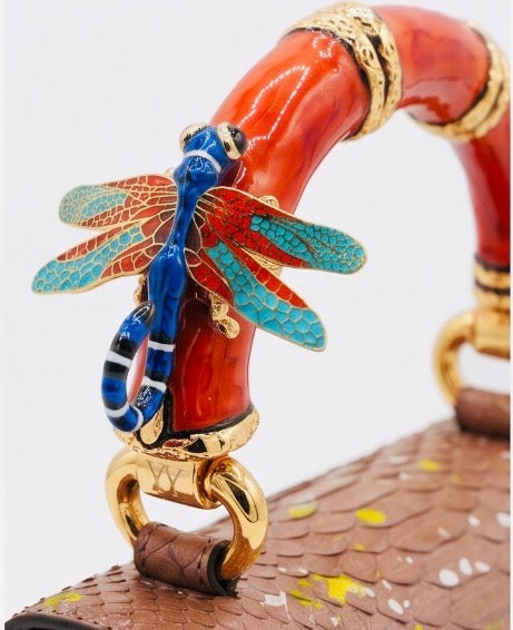 Poudre Python Art Bag with red top handle and blue dragonfly charm