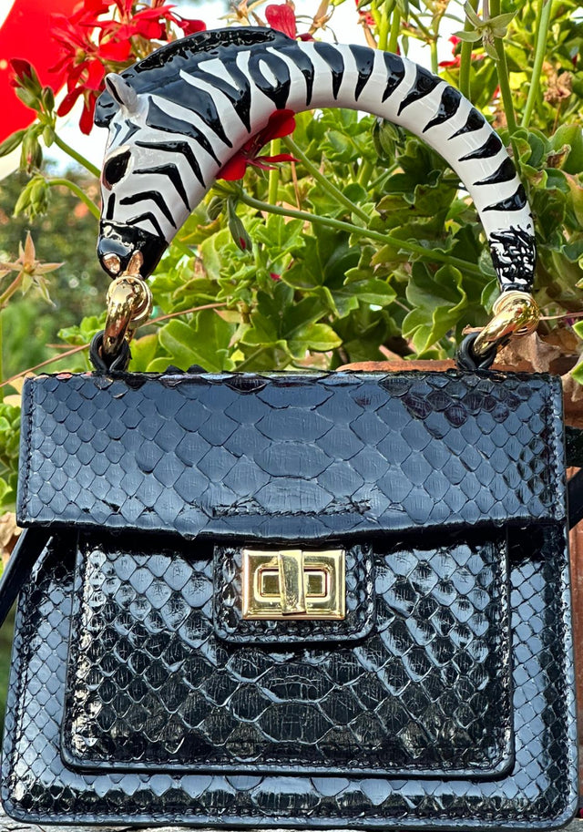 Python top handle bag with black zebra handle charm